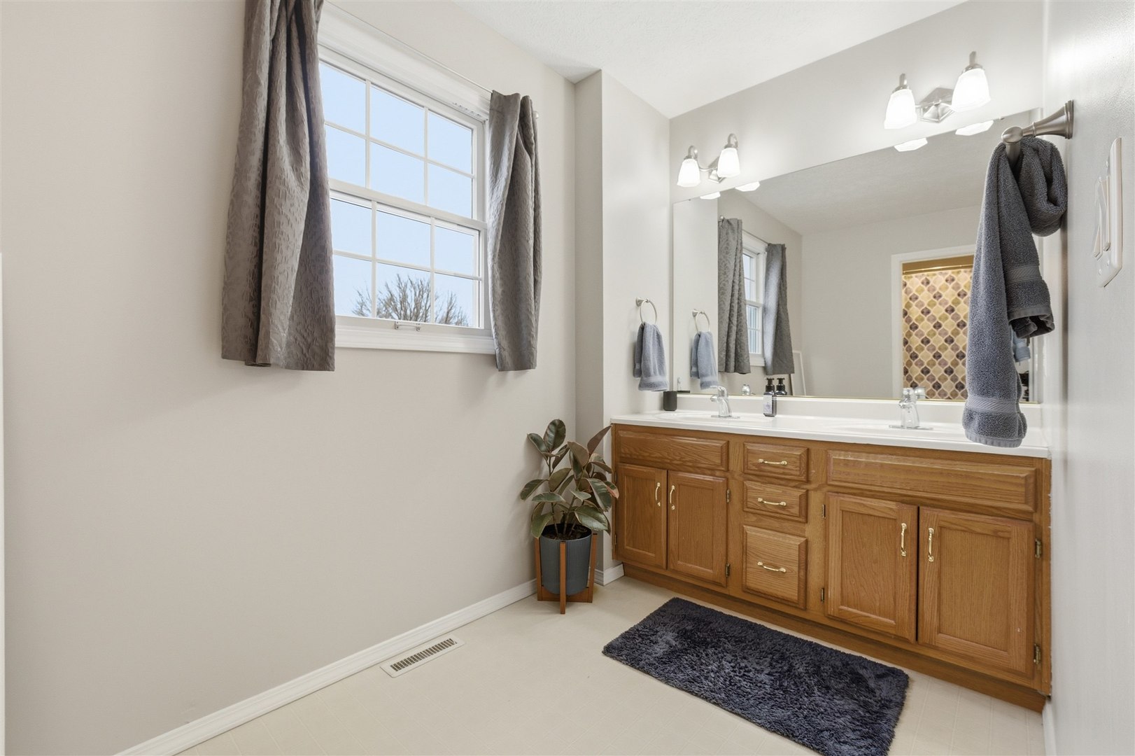 811 Landau Lane Normal, IL 61761 - Photo 17 of 34 a bathroom with a sink a vanity and mirror