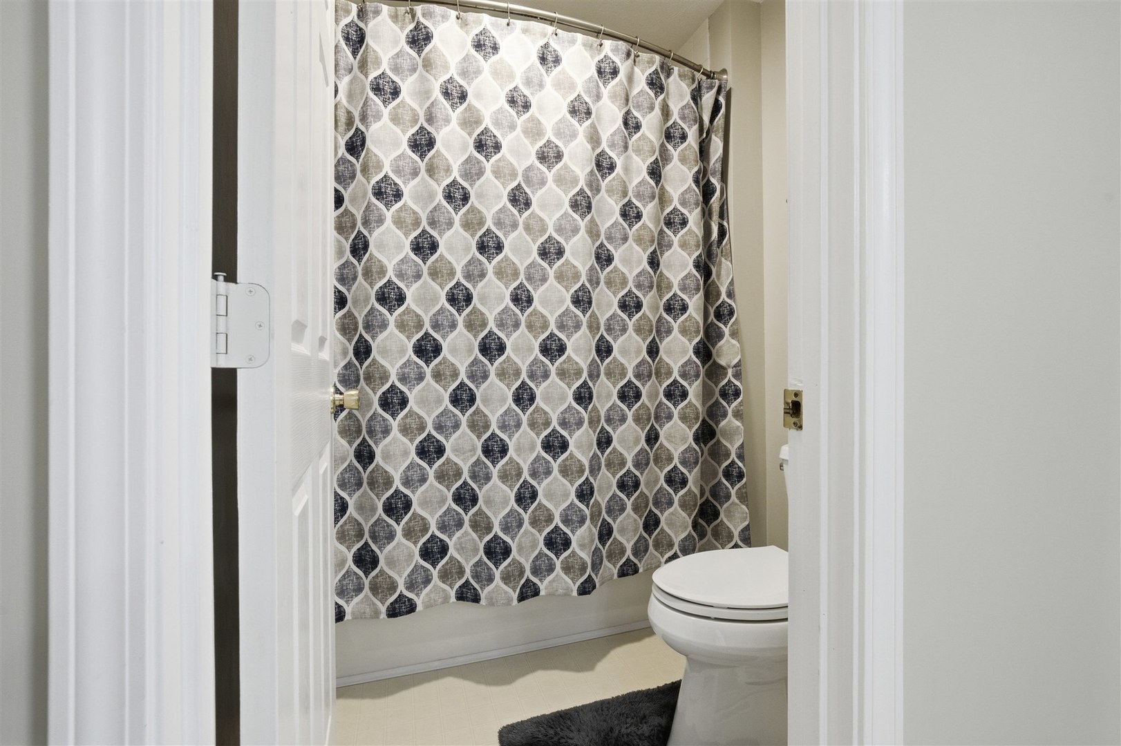 811 Landau Lane Normal, IL 61761 - Photo 18 of 34 a bathroom with a toilet and a shower curtain