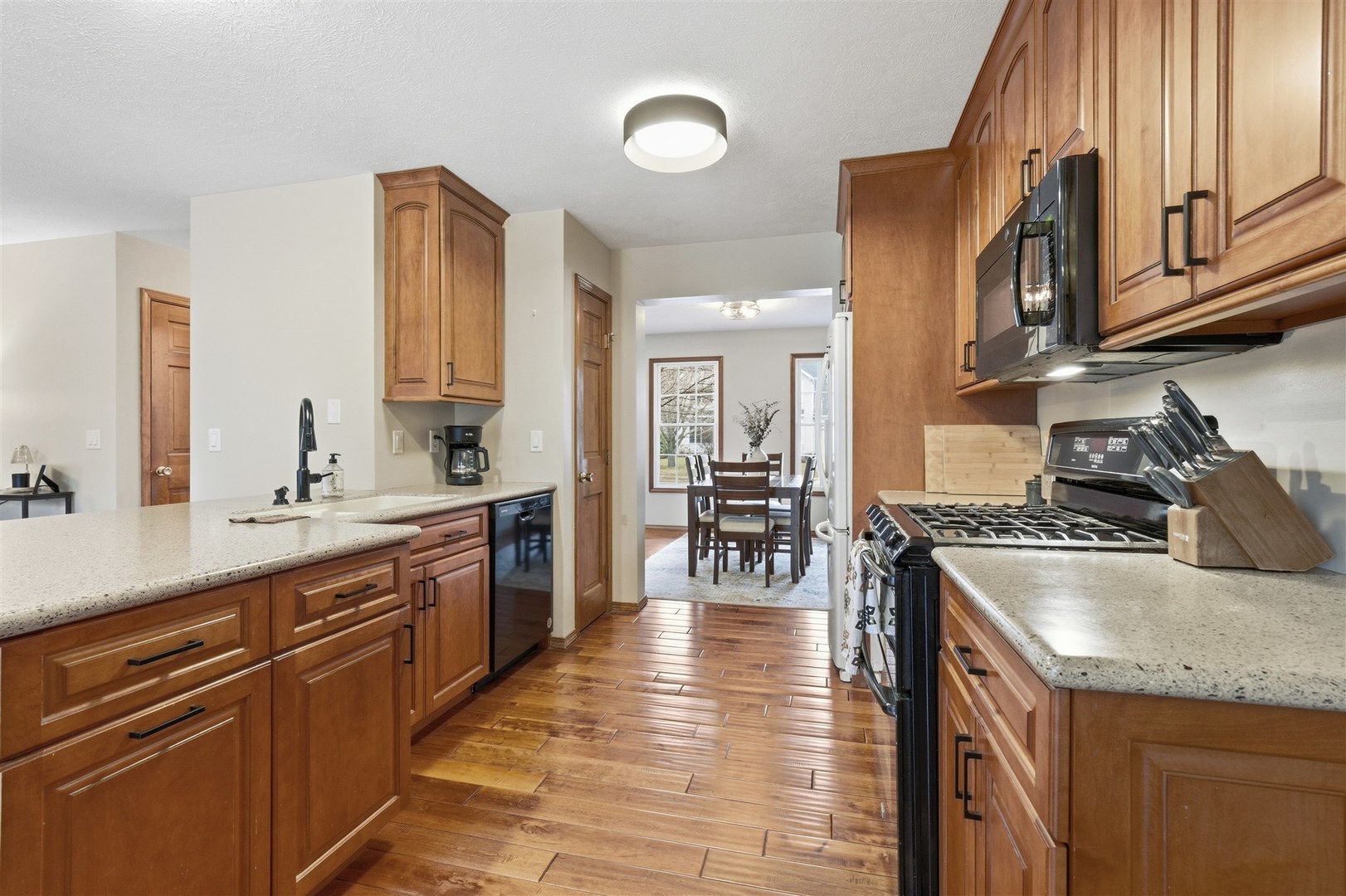811 Landau Lane Normal, IL 61761 - Photo 4 of 34 a kitchen with stainless steel appliances granite countertop a stove top oven a sink dishwasher and cabinets with wooden floor