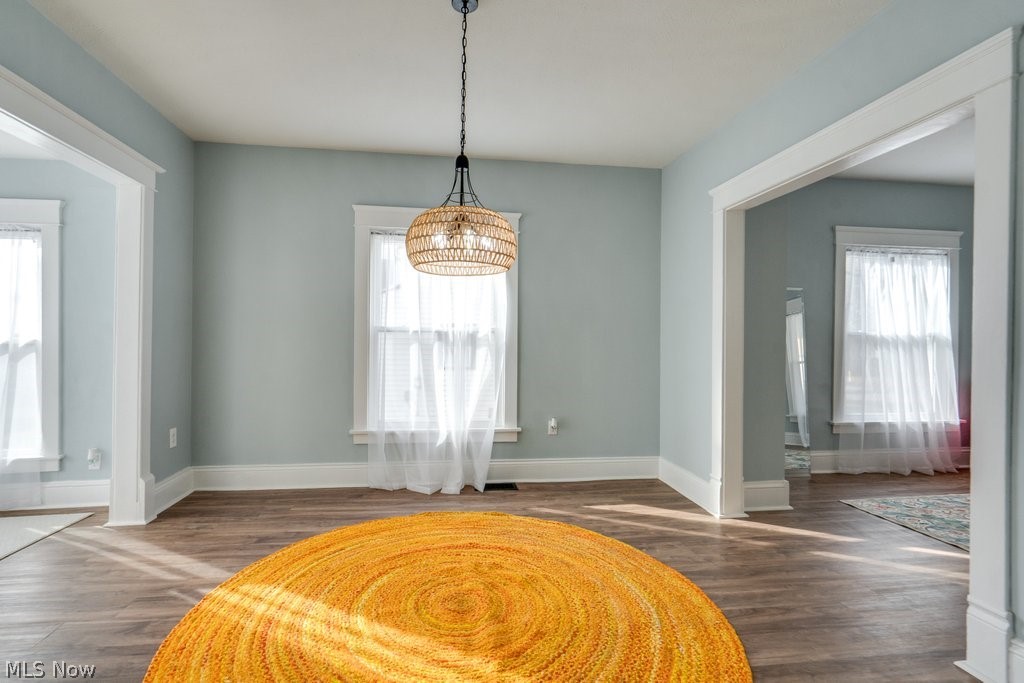 12 South 4th Street Rittman, OH 44270 - Photo 21 of 48 Unfurnished dining area with baseboards and dark wood-type flooring