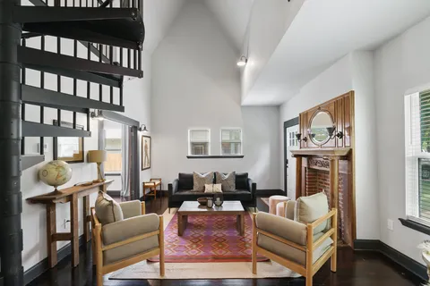 a living room with furniture a couch and a floor to ceiling window