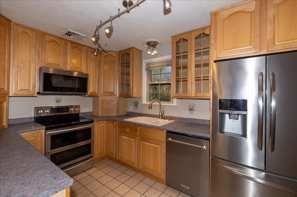 15 Wilbraham Road Hampden, MA 01036 - Photo 18 of 38 a kitchen with stainless steel appliances a refrigerator sink and microwave