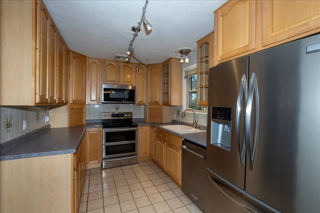 15 Wilbraham Road Hampden, MA 01036 - Photo 19 of 38 a kitchen with stainless steel appliances granite countertop a refrigerator and a stove top oven