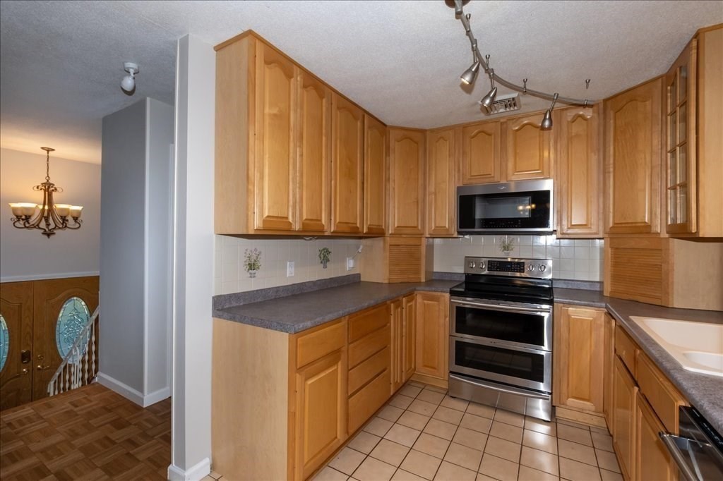 15 Wilbraham Road Hampden, MA 01036 - Photo 20 of 38 a kitchen with stainless steel appliances a stove sink microwave and cabinets