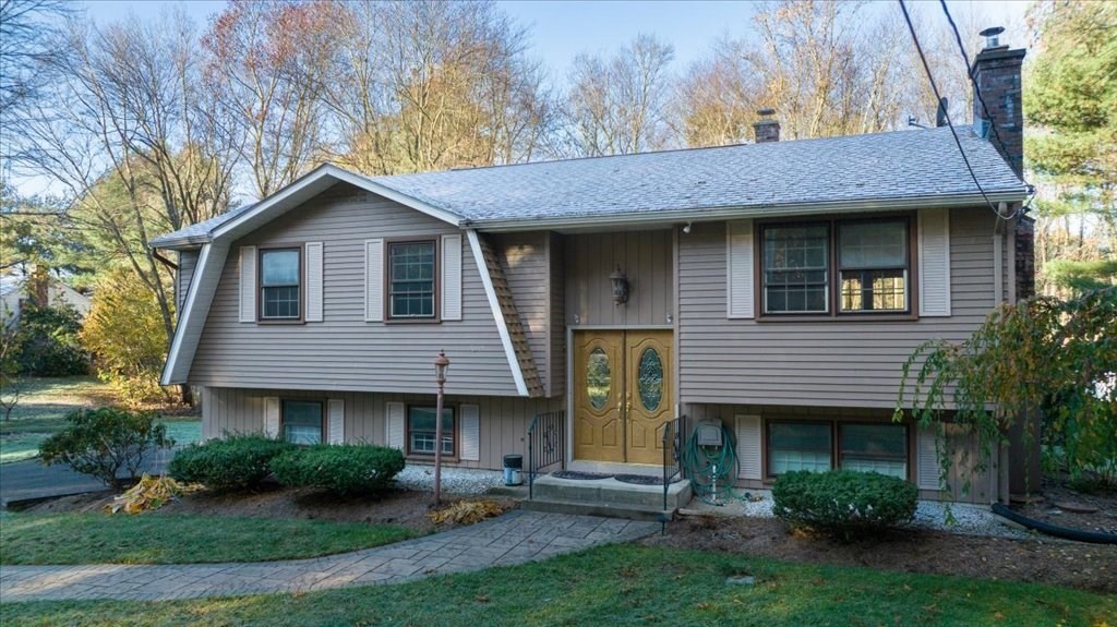 15 Wilbraham Road Hampden, MA 01036 - Photo 2 of 38 a view of a brick house with a yard plants and large tree