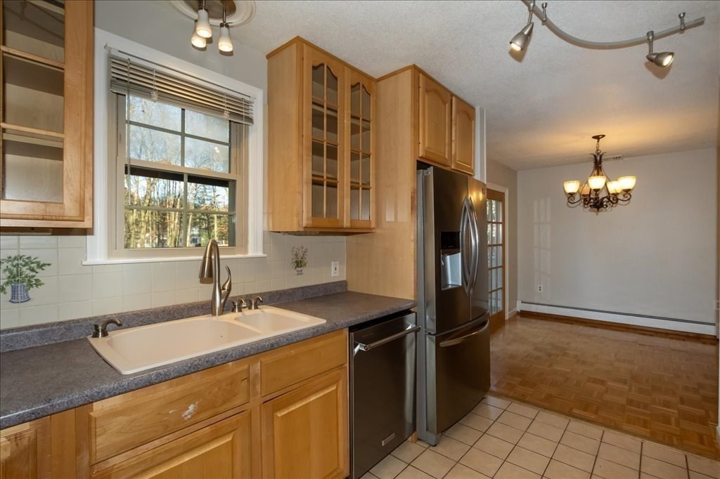 15 Wilbraham Road Hampden, MA 01036 - Photo 21 of 38 a kitchen with stainless steel appliances granite countertop a sink and a refrigerator