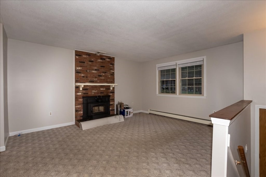 15 Wilbraham Road Hampden, MA 01036 - Photo 25 of 38 a view of an empty room with a fireplace and a window