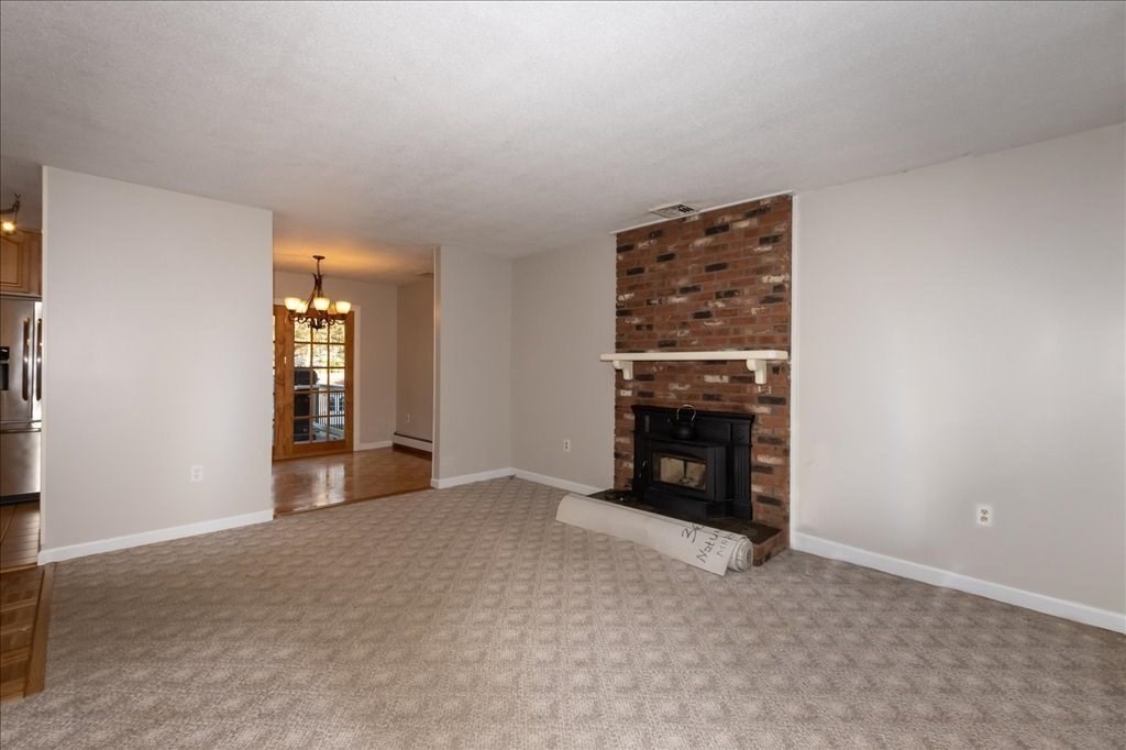 15 Wilbraham Road Hampden, MA 01036 - Photo 26 of 38 an empty room with windows and a fireplace