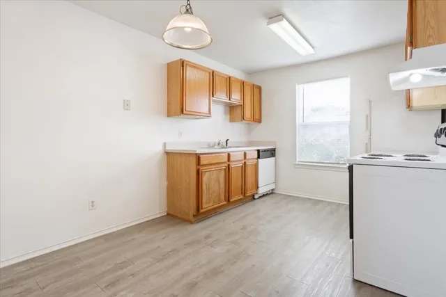 a view of a kitchen with a sink cabinets and a window