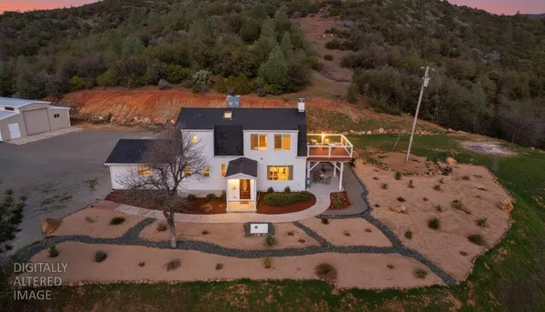 an aerial view of a house with a yard