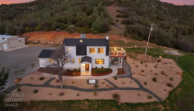 an aerial view of a house with a yard