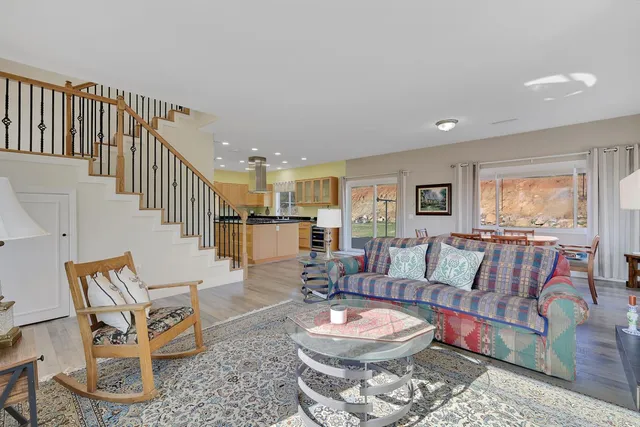 a kitchen with stainless steel appliances granite countertop a sink a stove and a refrigerator