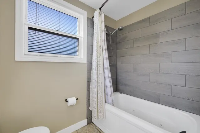 a bedroom with a large bed and a tv