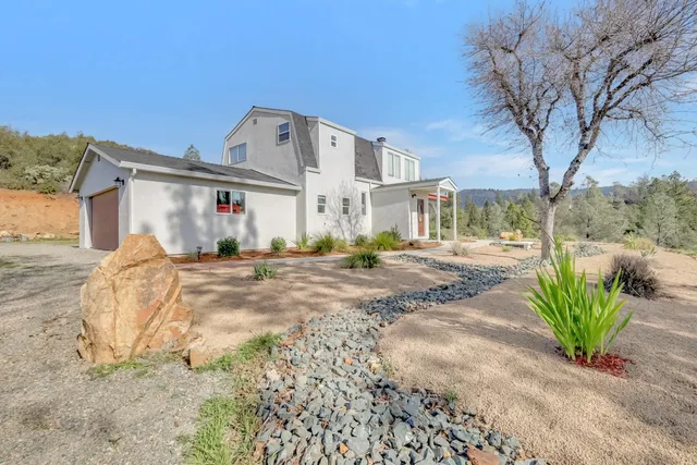 a kitchen with granite countertop a sink a counter top space cabinets and stainless steel appliances
