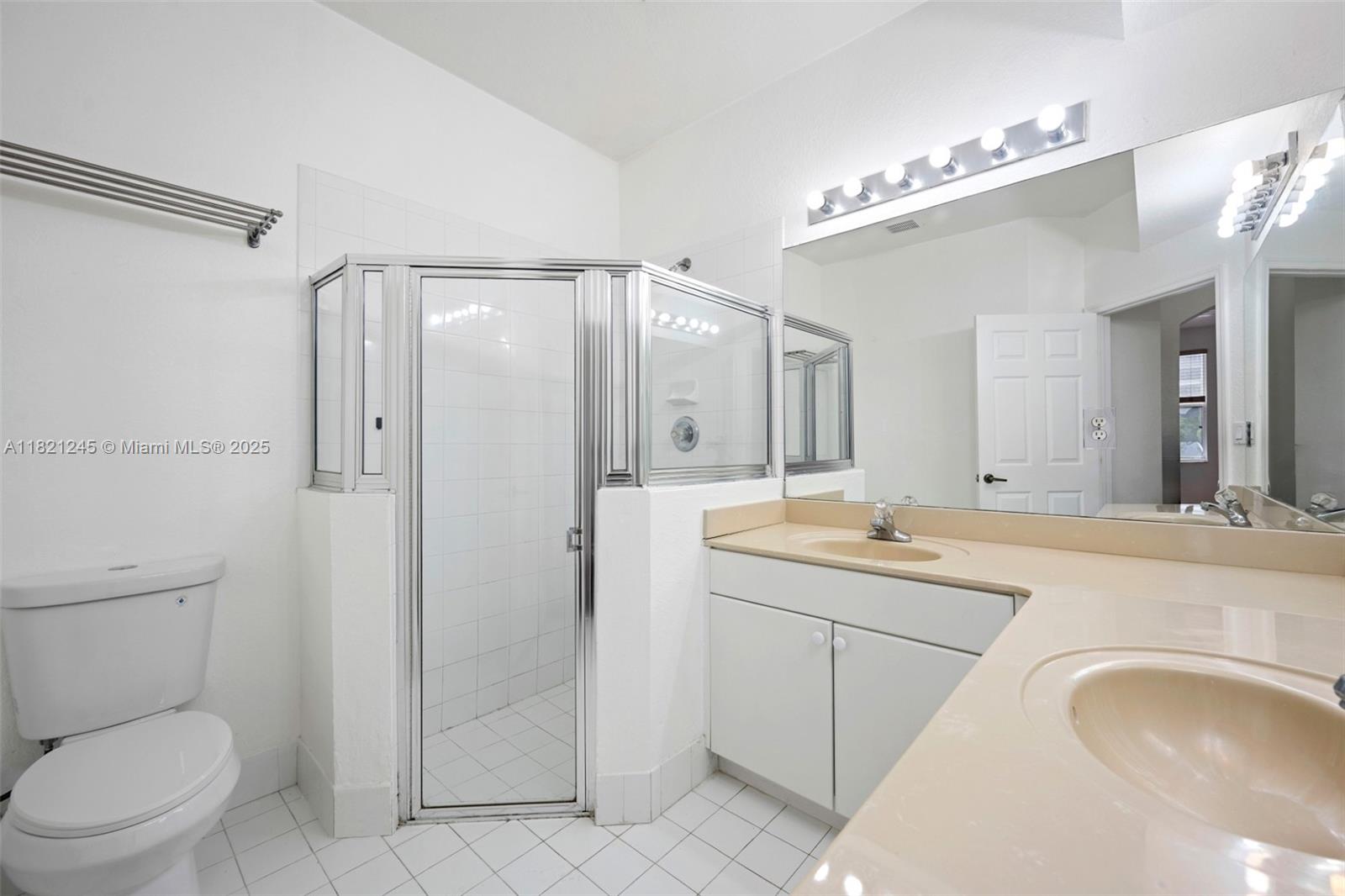 7633 Northwest 114th Path, Unit 7633 Doral, FL 33178 - Photo 11 of 25 a spacious bathroom with a granite countertop sink a toilet a mirror and shower