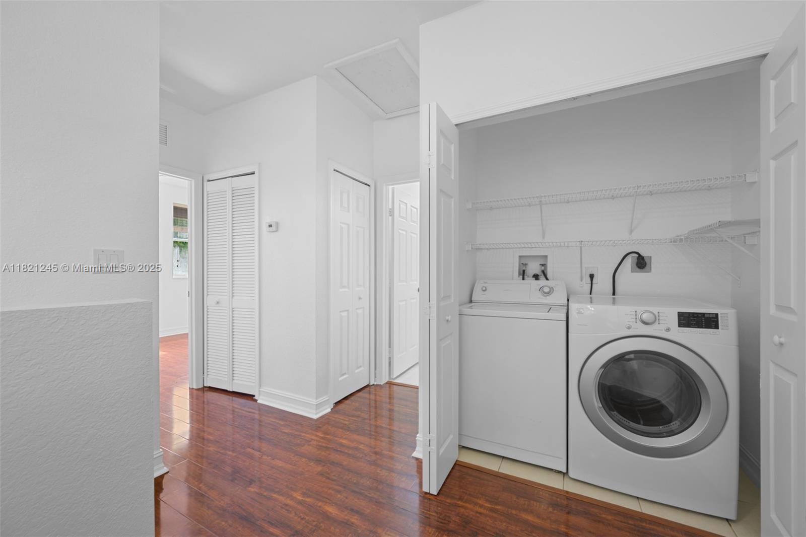 7633 Northwest 114th Path, Unit 7633 Doral, FL 33178 - Photo 12 of 25 a view of a hallway with washer and dryer