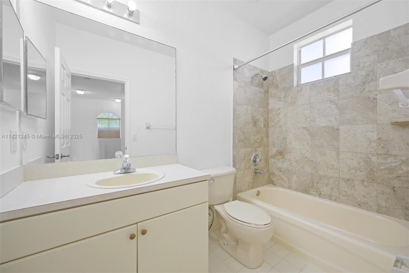 7633 Northwest 114th Path, Unit 7633 Doral, FL 33178 - Photo 16 of 25 a bathroom with a sink a toilet and shower