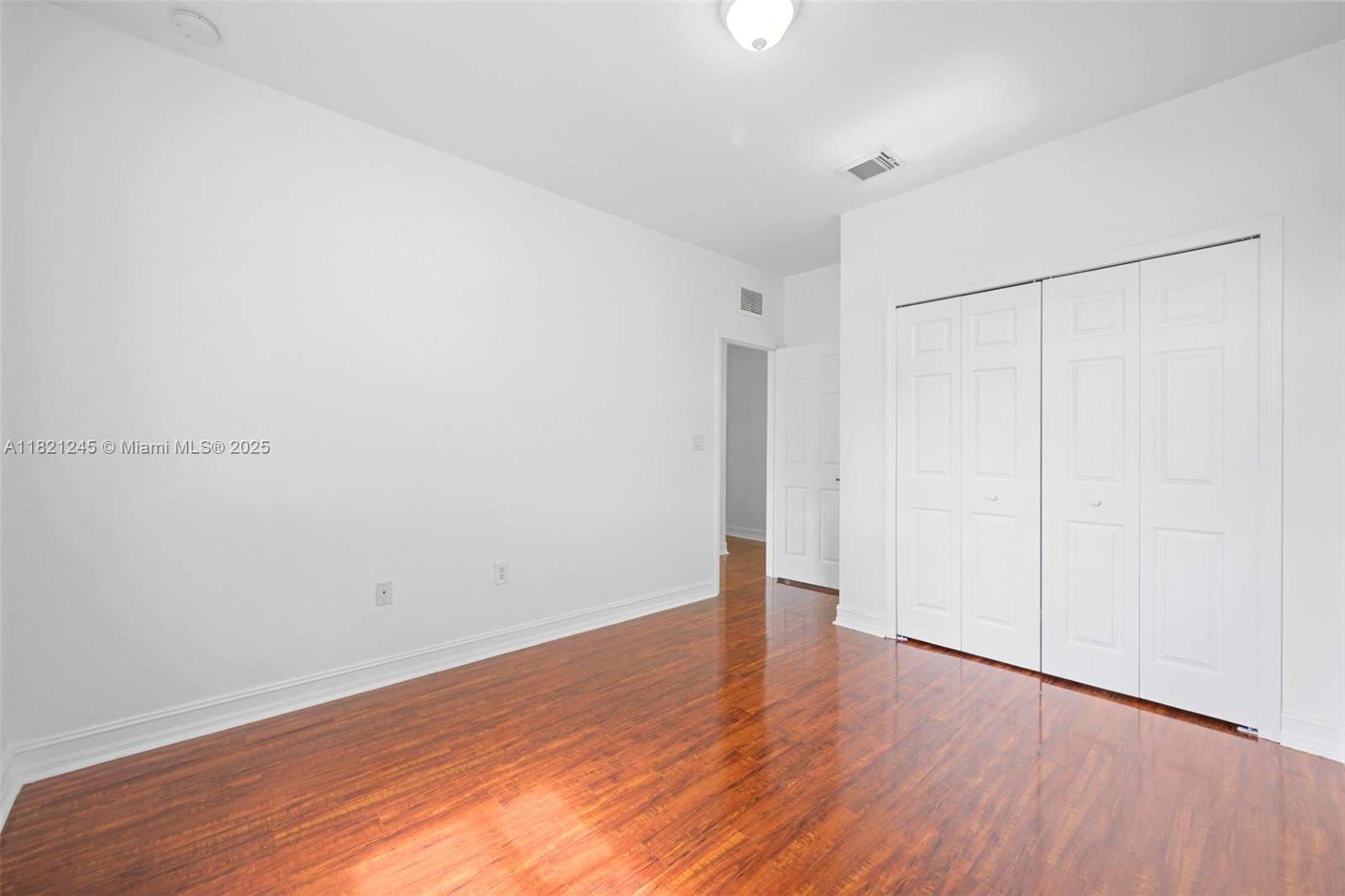 7633 Northwest 114th Path, Unit 7633 Doral, FL 33178 - Photo 18 of 25 a view of an empty room with wooden floor