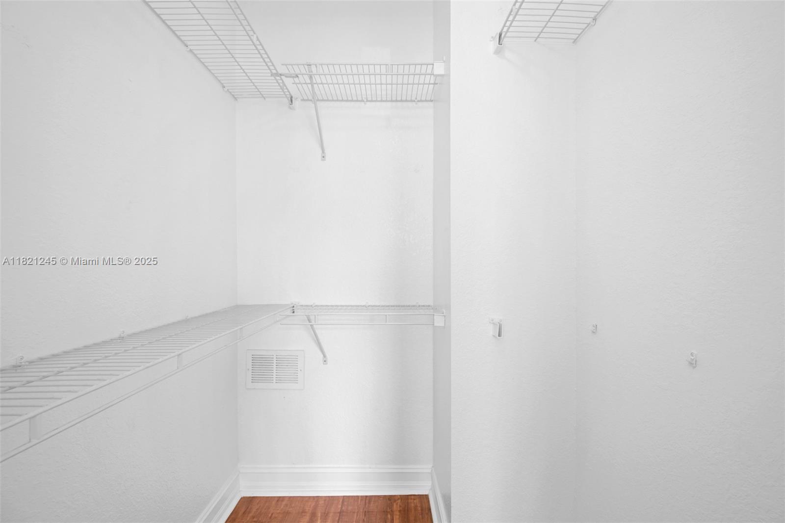 7633 Northwest 114th Path, Unit 7633 Doral, FL 33178 - Photo 19 of 25 a view of walk in closet with empty racks