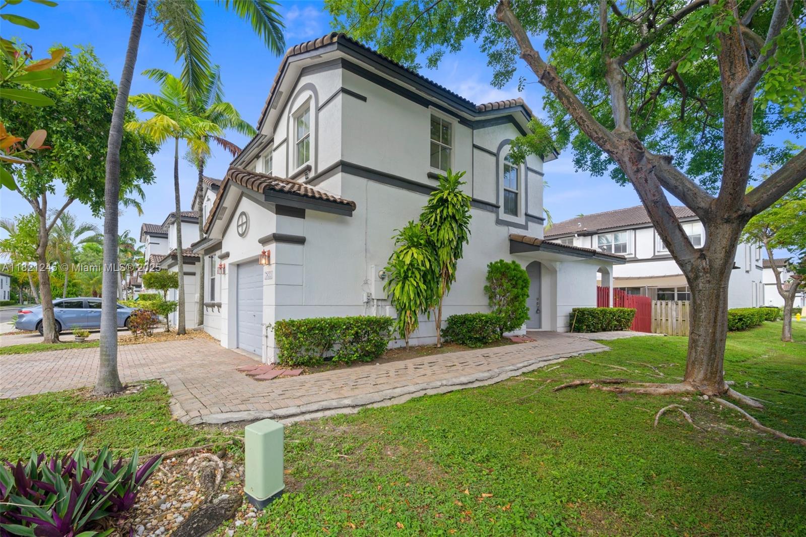 7633 Northwest 114th Path, Unit 7633 Doral, FL 33178 - Photo 24 of 25 a front view of a house with garden