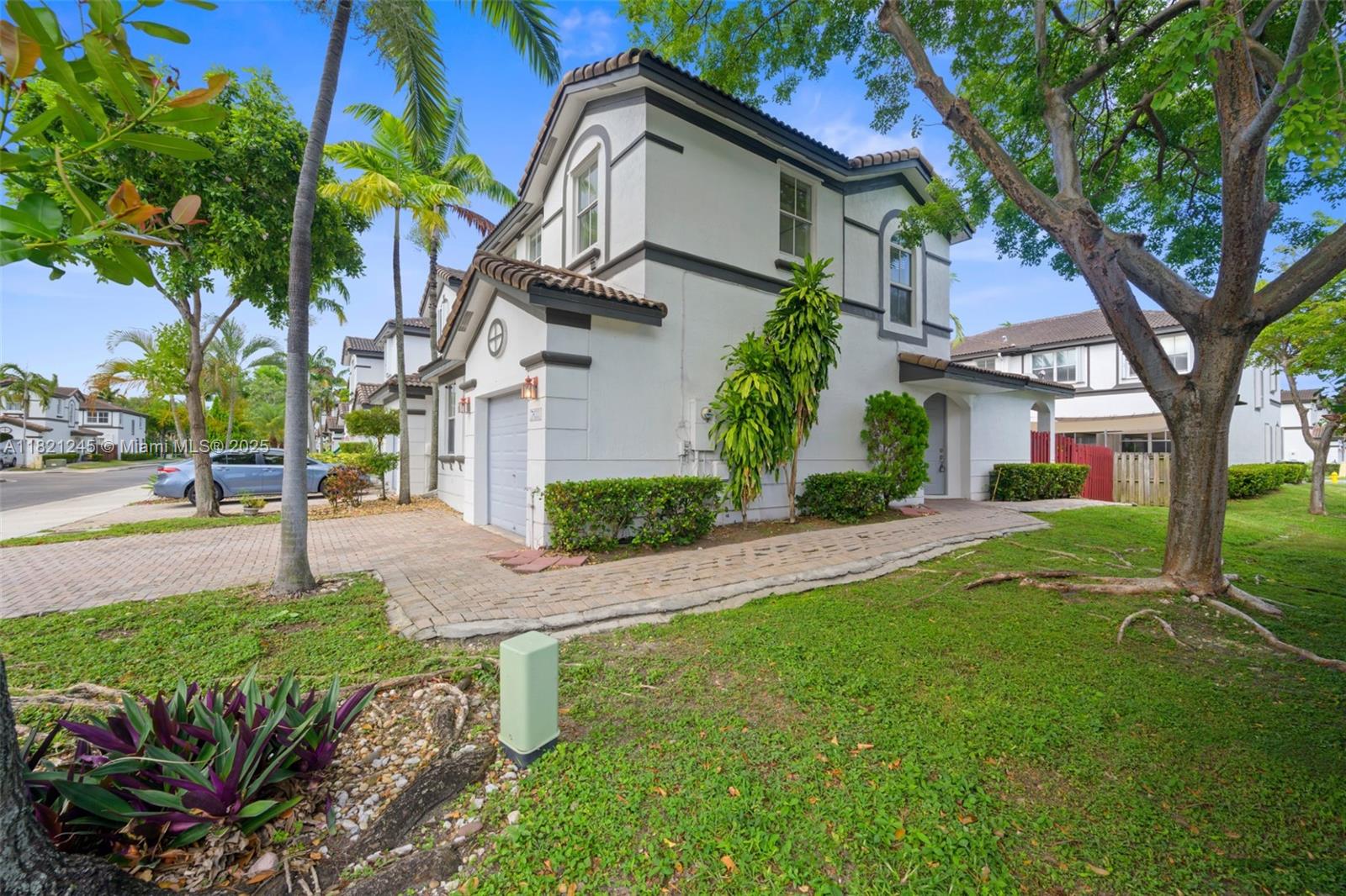7633 Northwest 114th Path, Unit 7633 Doral, FL 33178 - Photo 25 of 25 a house that has a tree in front of it