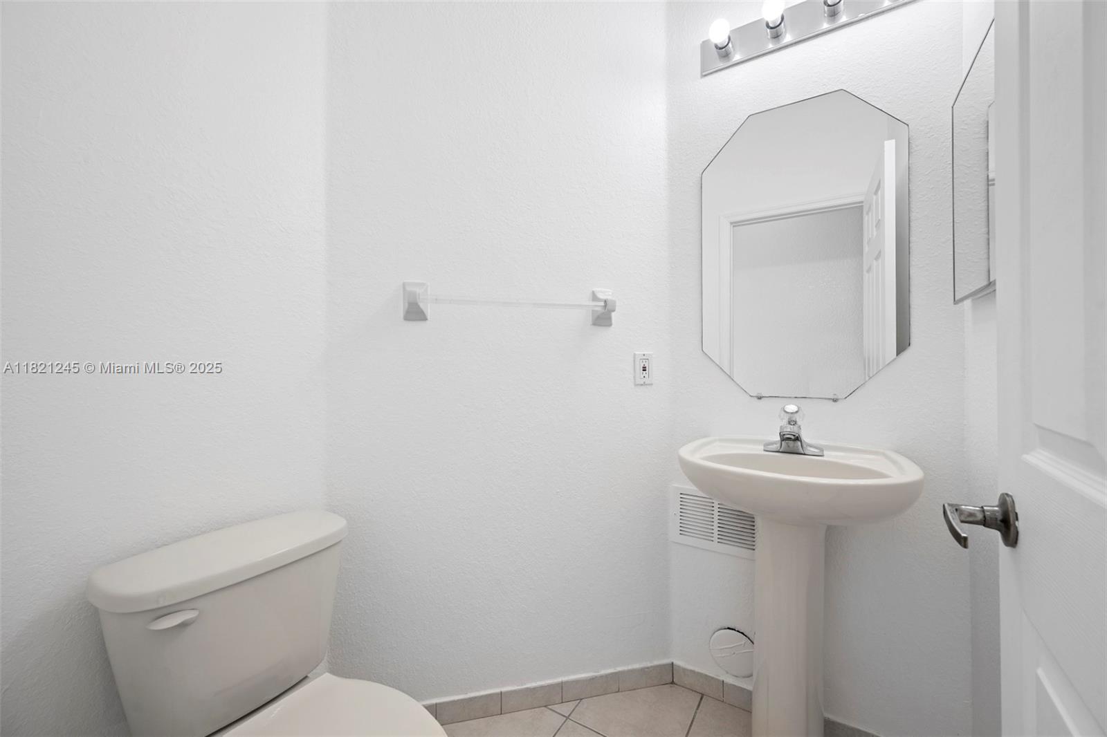 7633 Northwest 114th Path, Unit 7633 Doral, FL 33178 - Photo 8 of 25 a bathroom with a toilet sink and mirror