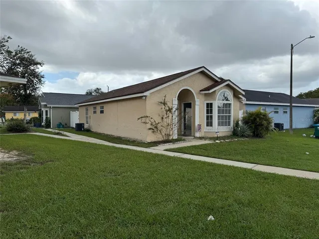 a front view of a house with a garden and yard