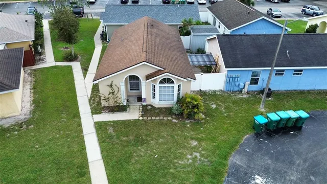 an aerial view of a house with a yard