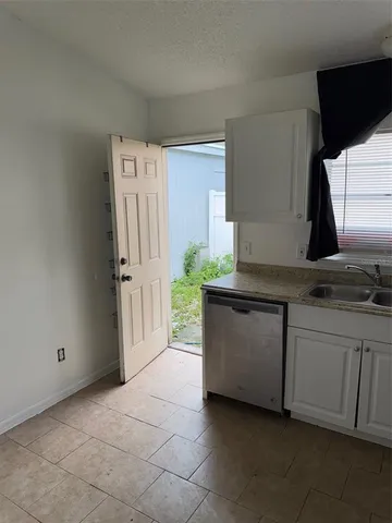 a kitchen with granite countertop a sink and a stove