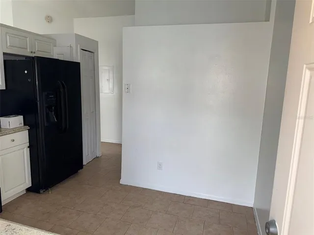 a kitchen with white cabinets and appliances