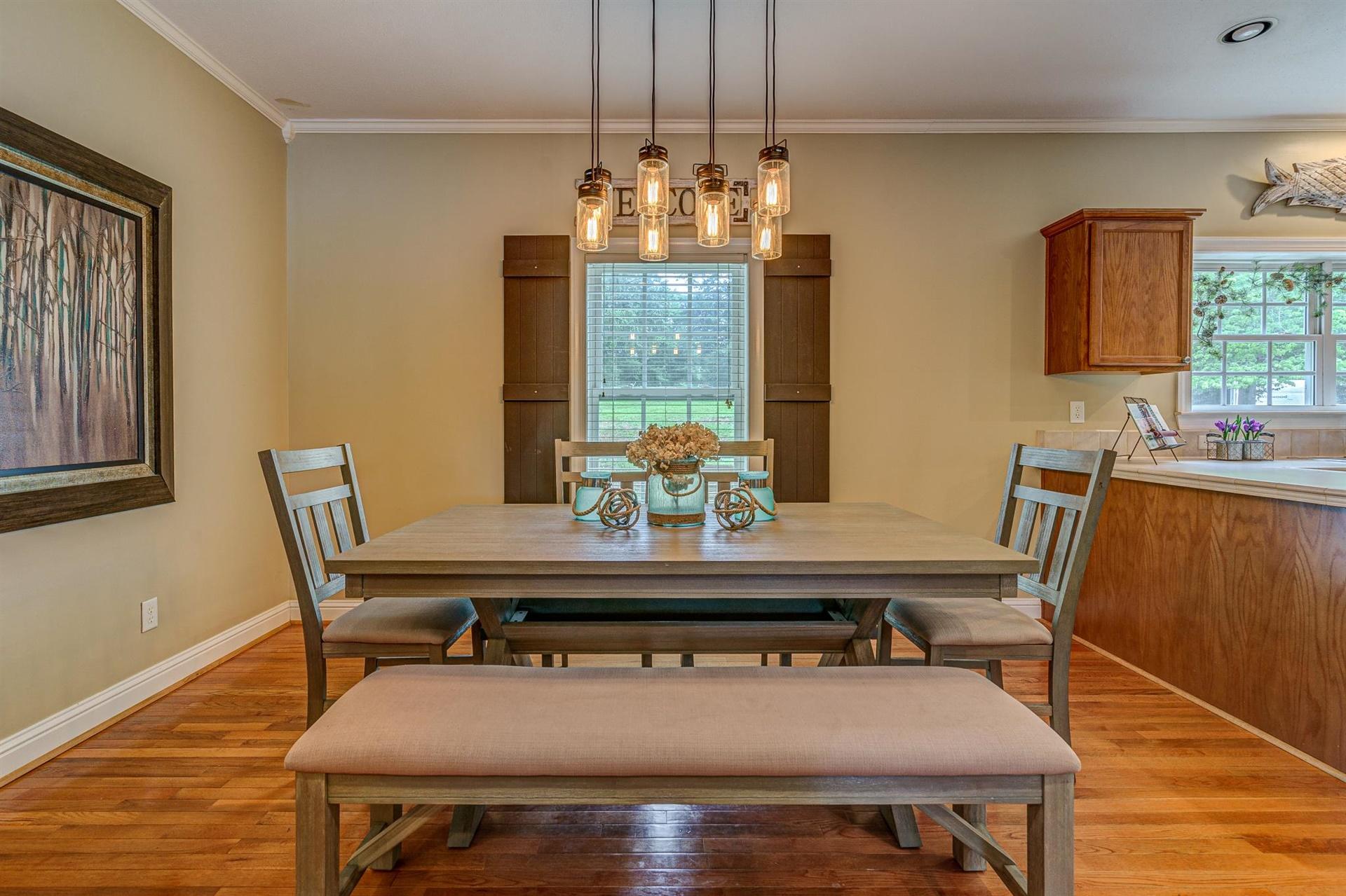 231 Spence Road Union Hall, VA 24176 - Photo 22 of 61 a dining room with furniture a chandelier and wooden floor
