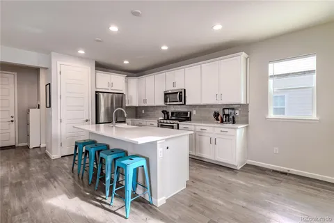 a kitchen with stainless steel appliances a stove a microwave and cabinets