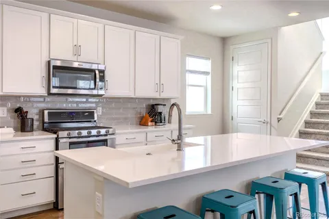 a kitchen with stainless steel appliances a stove a microwave and cabinets