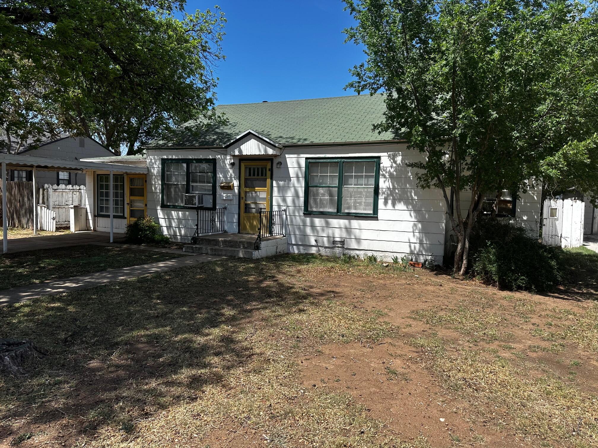 2612 36th Street Lubbock, TX 79413 - Photo 1 of 30 a front view of a house with a garden