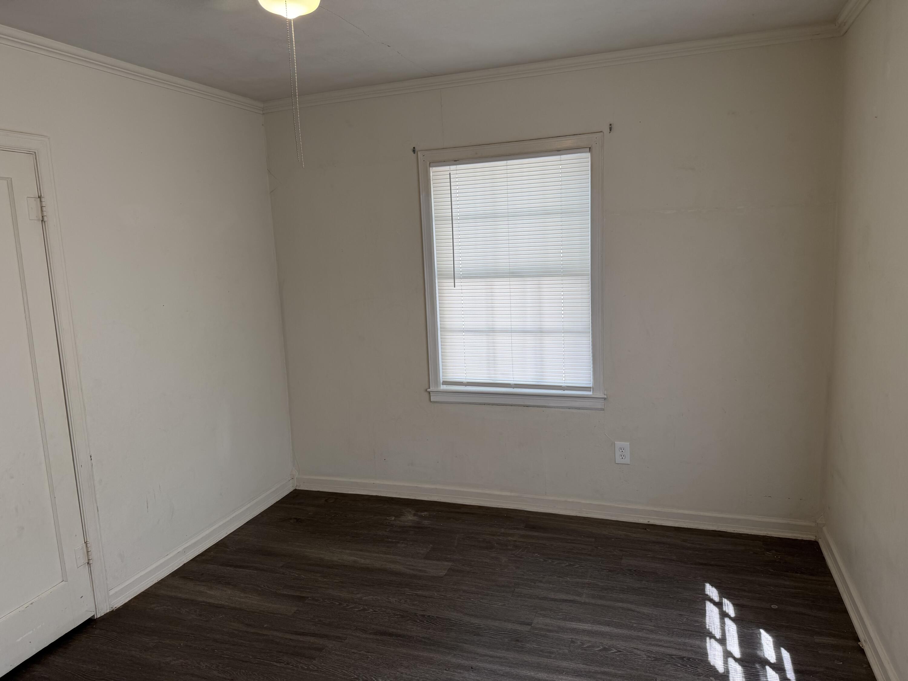 2612 36th Street Lubbock, TX 79413 - Photo 14 of 30 an empty room with wooden floor and windows
