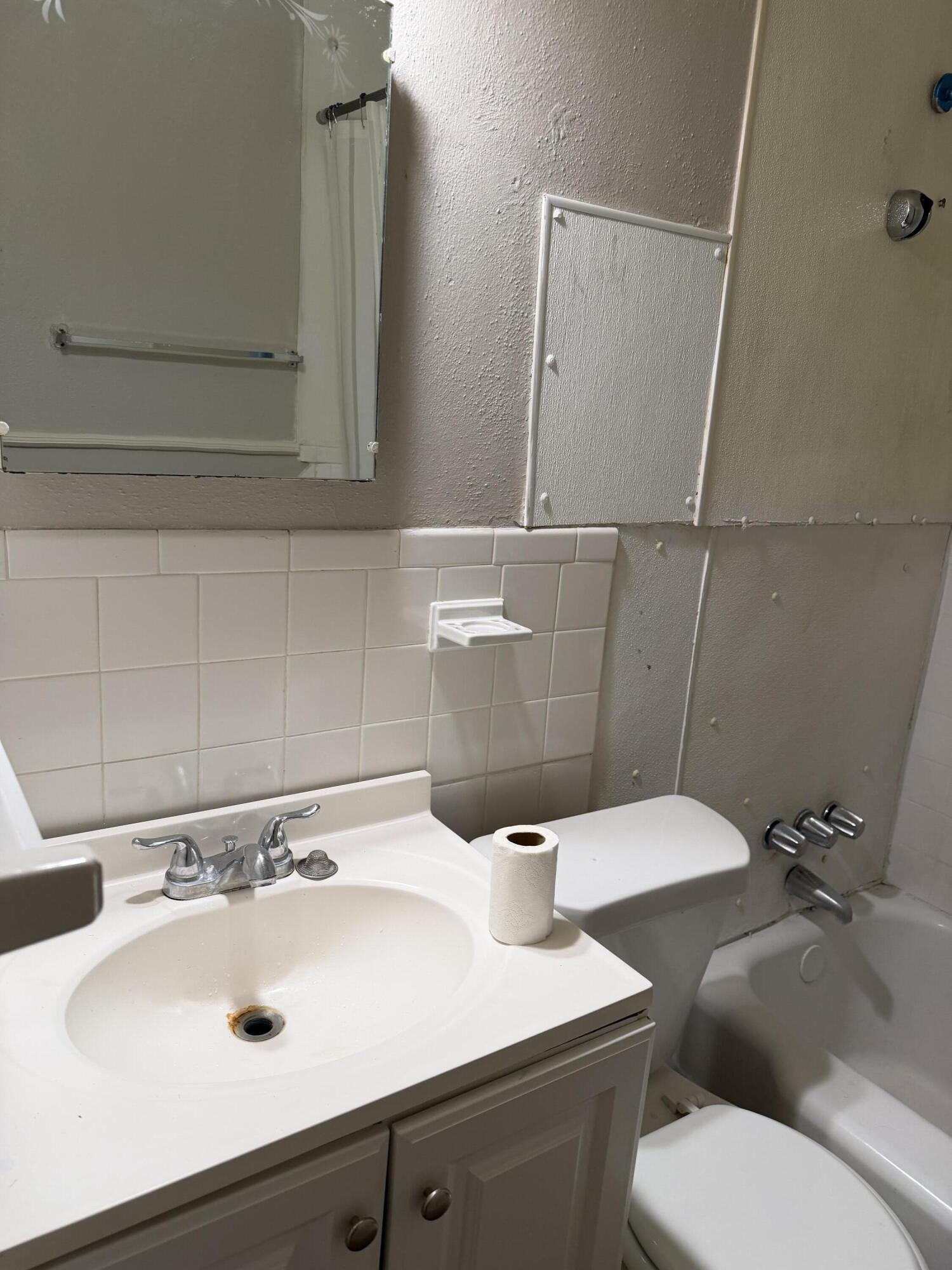 2612 36th Street Lubbock, TX 79413 - Photo 6 of 30 a bathroom with a sink and a mirror