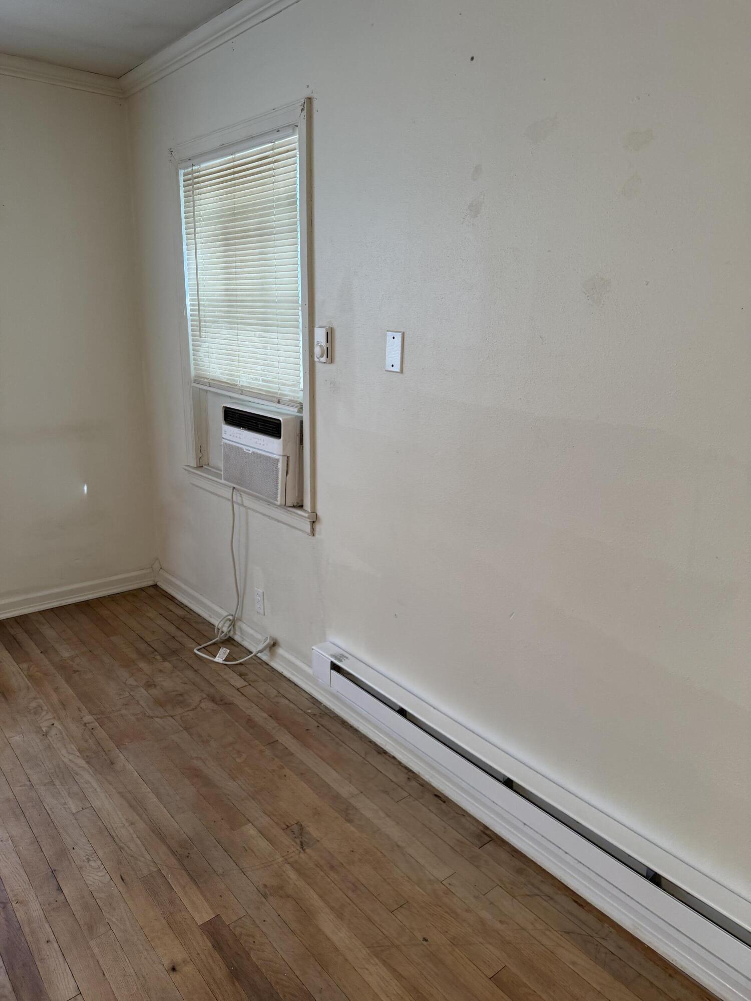 2612 36th Street Lubbock, TX 79413 - Photo 10 of 30 an empty room with wooden floor and windows