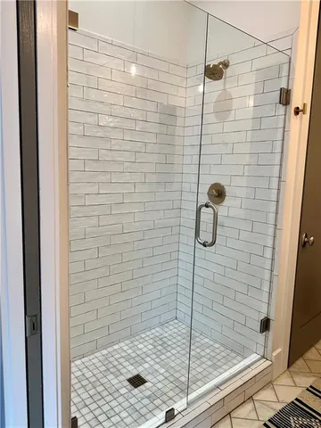 a view of a hallway with wooden floor and glass door