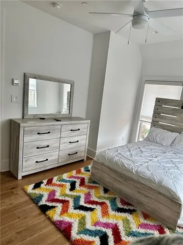 a bathroom with a sink a toilet a mirror and shower