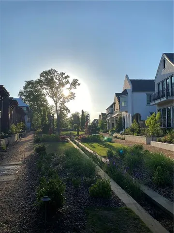 a view of a green field with some trees in the background