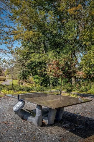 a view of a lake with a table and chairs