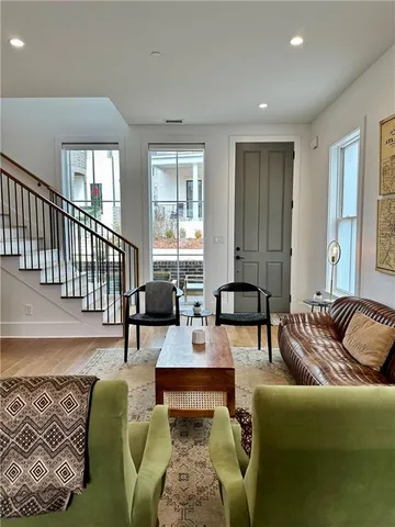 a living room with furniture and wooden floor