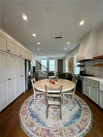 a stove top oven sitting inside of a kitchen