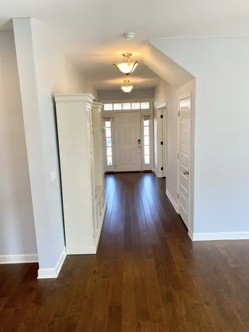 a view of a room with wooden floor and staircase