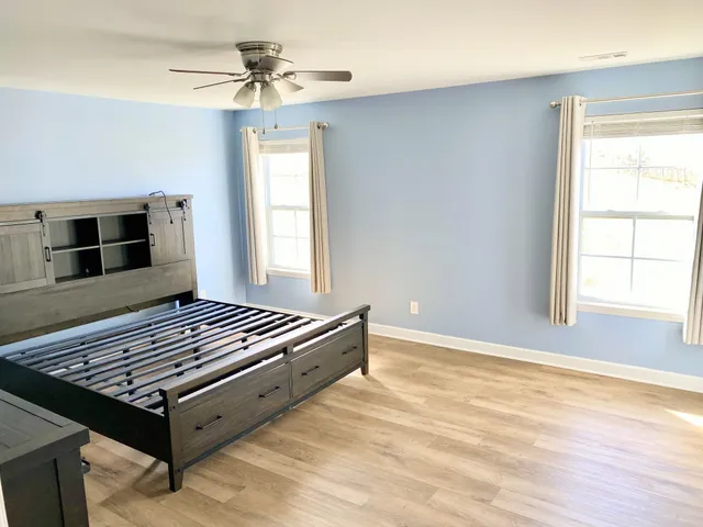 a living room with furniture pool table and window