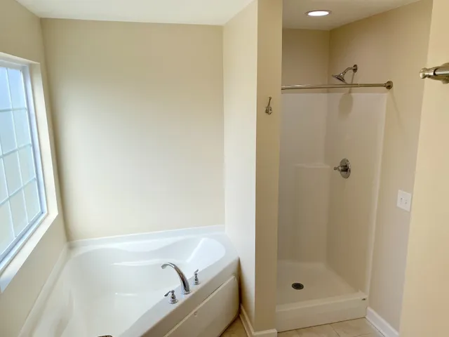 a bathroom with a tub and shower