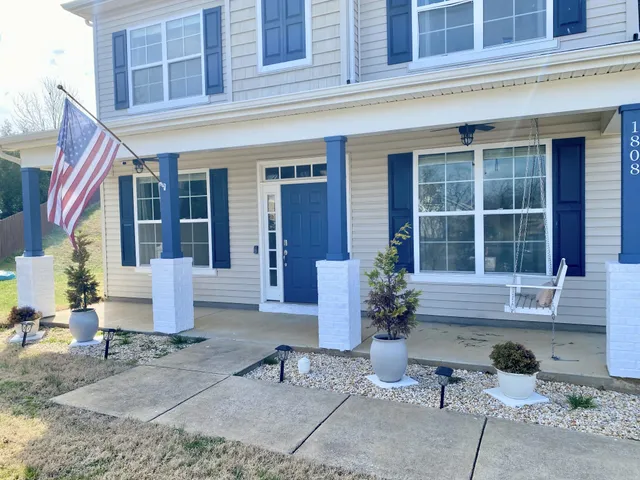 a view of brick house with potted plants