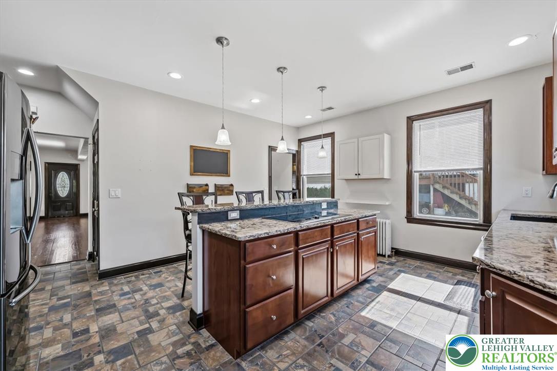 3453 Main Street Slatington, PA 18080 - Photo 6 of 30 Culinary delights await in this modern kitchen with an island cooktop and rich wood cabinetry.