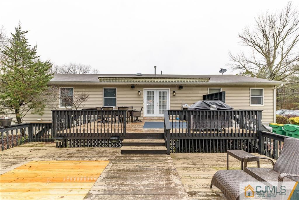 22 Tower Road Cream Ridge, NJ 08514 - Photo 22 of 25 a view of a patio with a table and chairs and wooden fence