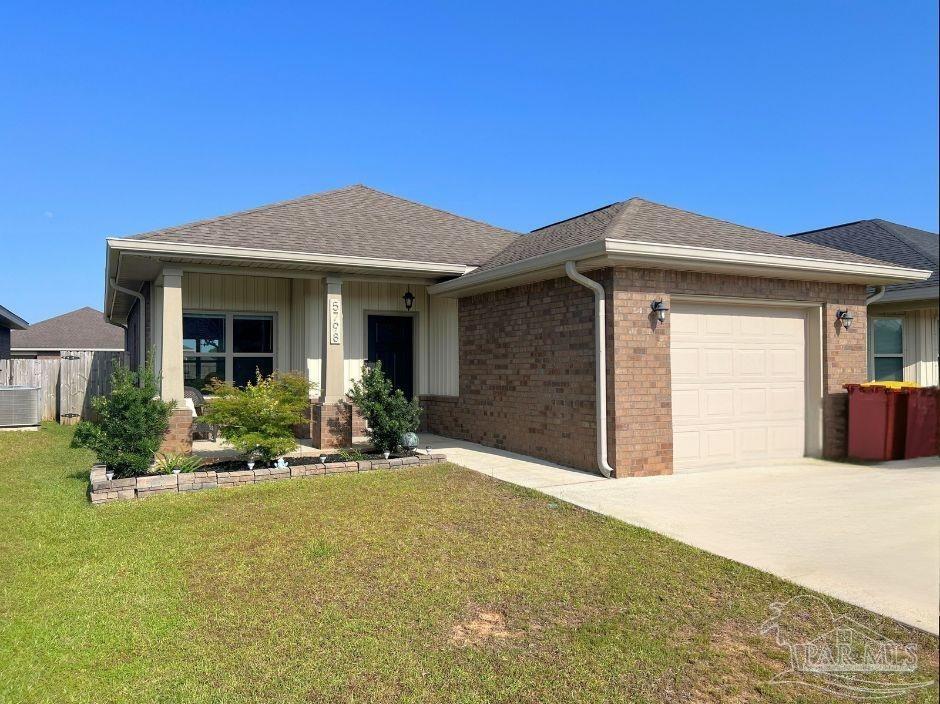 a front view of a house with yard outdoor seating and garage